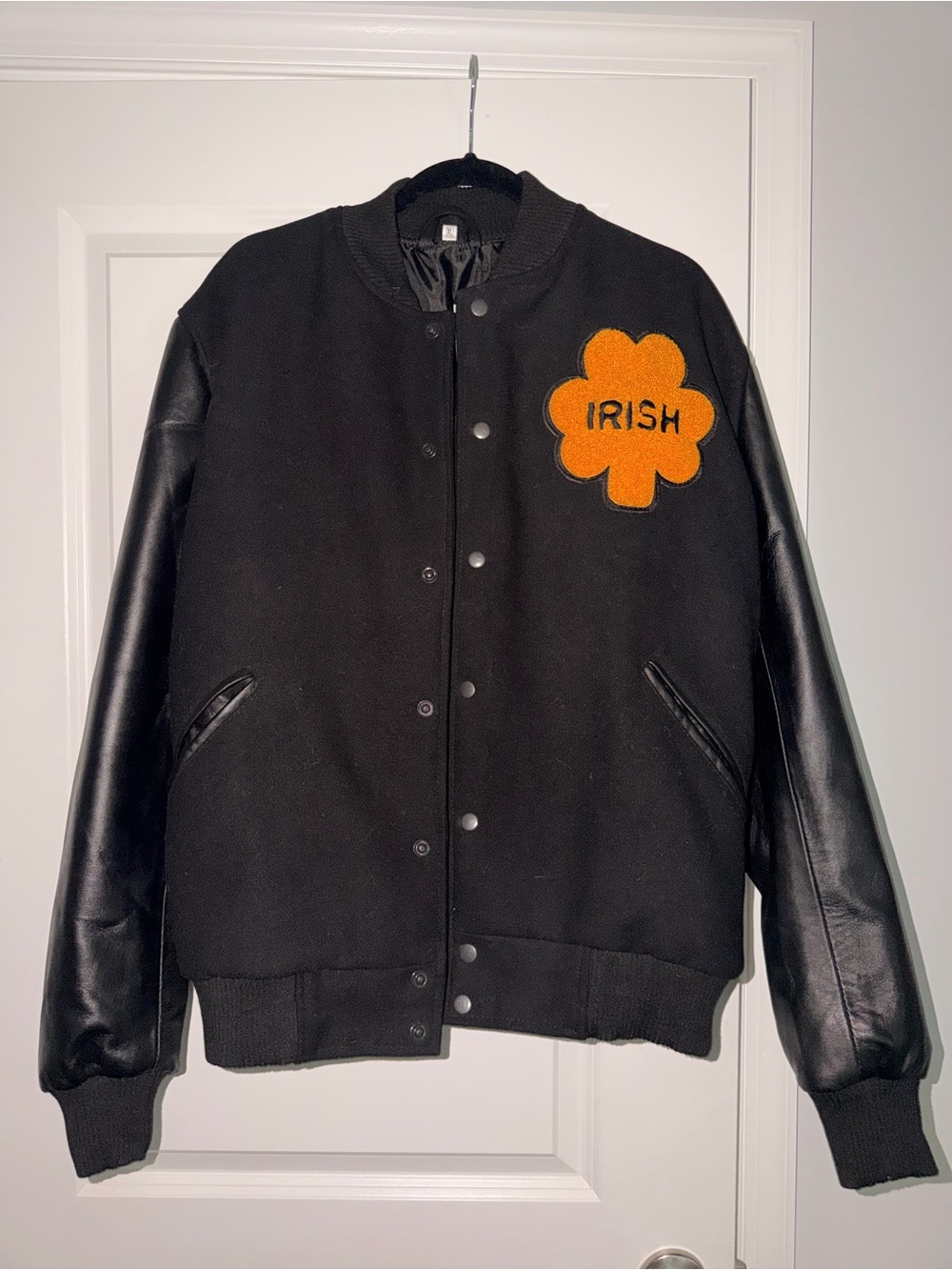 Black Letterman-Style Jacket with Orange 'Irish' Patch